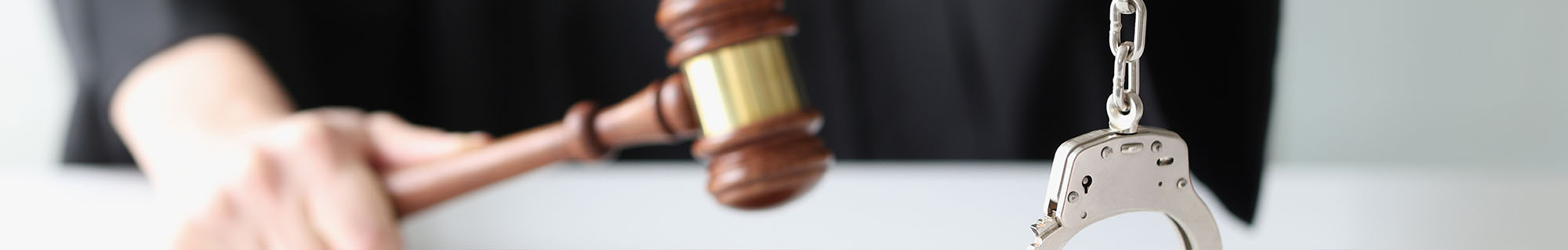 Judge Holds a Gavel and Handcuffs